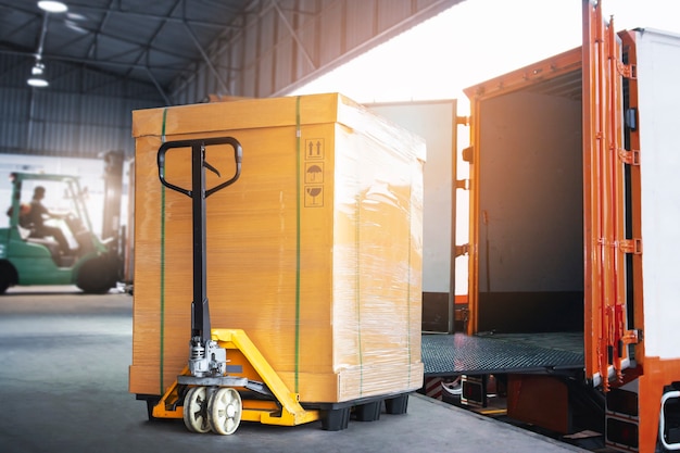 Cargo Box with Hand Pallet Truck is Loading into a Container  Shipment Delivery Warehouse Logistics