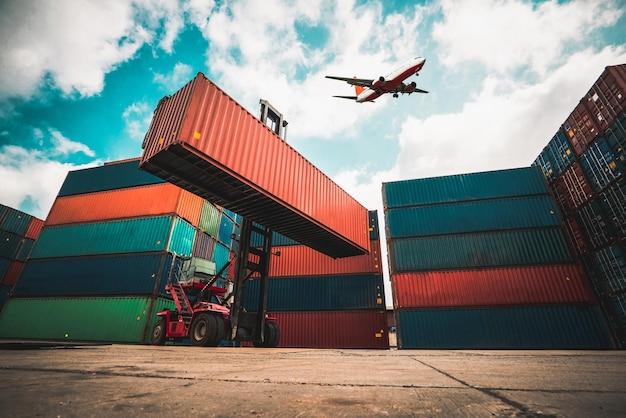 Cargo container for overseas shipping in shipyard with airplane in the sky