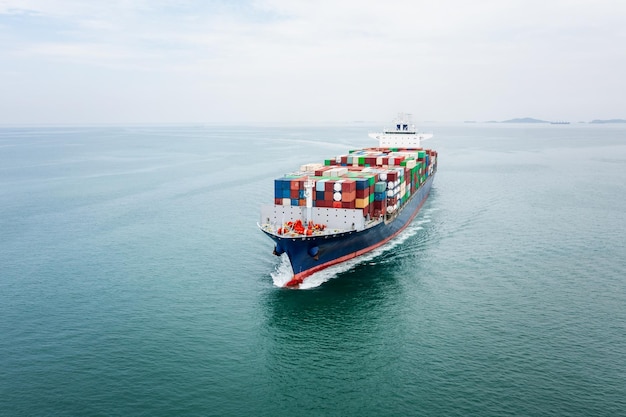 Cargo container ship sailing in sea import and export business and industry logistic goods