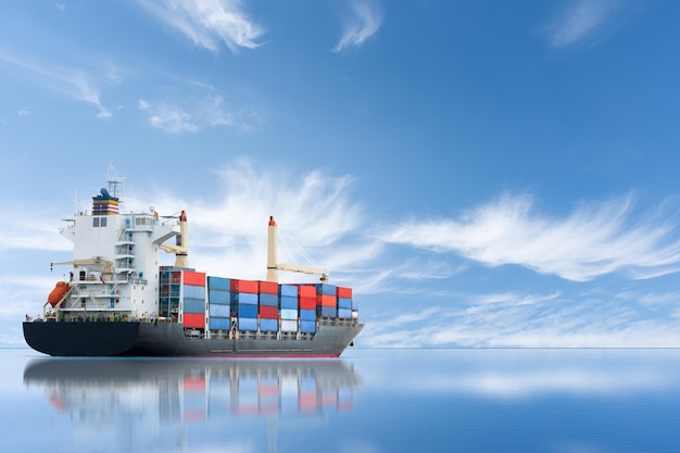 Cargo ship carrying container and running for export goods from cargo yard port to other ocean concept freight shipping ship on blue sky background