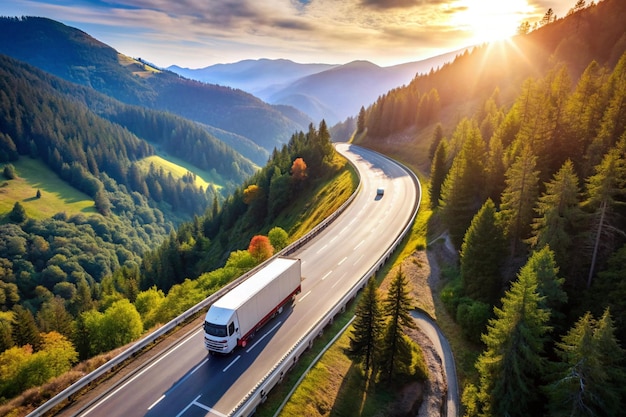 Photo cargo truck on the higthway cargo delivery driving on asphalt road through the mountains seen from the air aerial view landscape drone photography