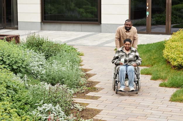 Caring Couple with Partner in Wheelchair