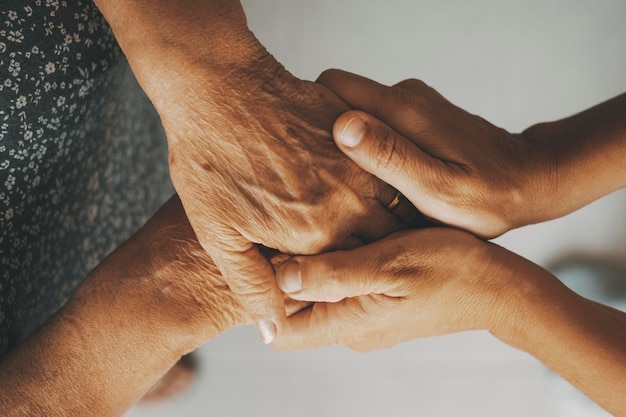 Caring elderly grandma wife holding hand supporting senior grandpa husband give empathy care love old married grandparents couple together two man and woman hope understanding concept close up view