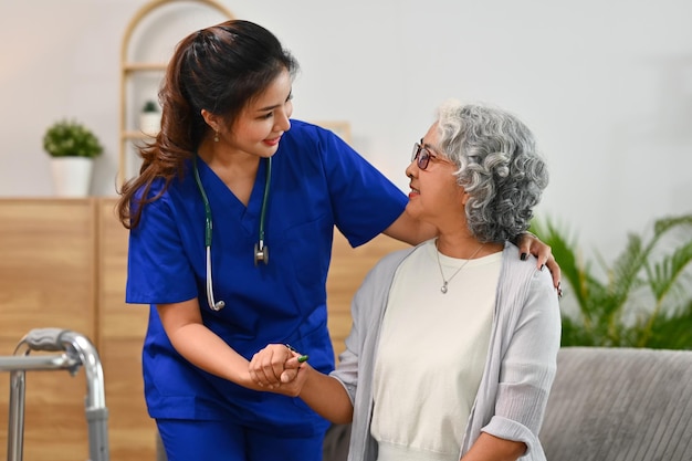 Caring healthcare worker talking while visiting senior woman patient at home Healthcare concept