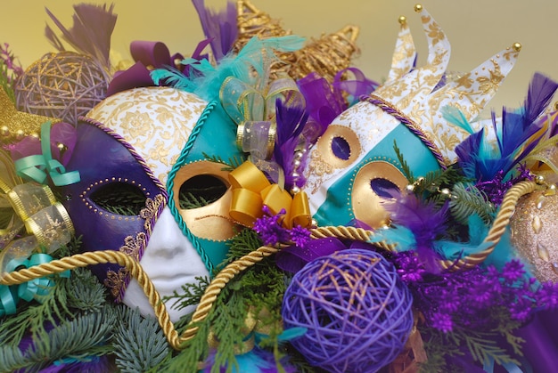 Carnival Arrangement with Mask Porcellain - Masquerade, Ornaments, fir Branches, Baubbles, Ribbons and Golden Decorations