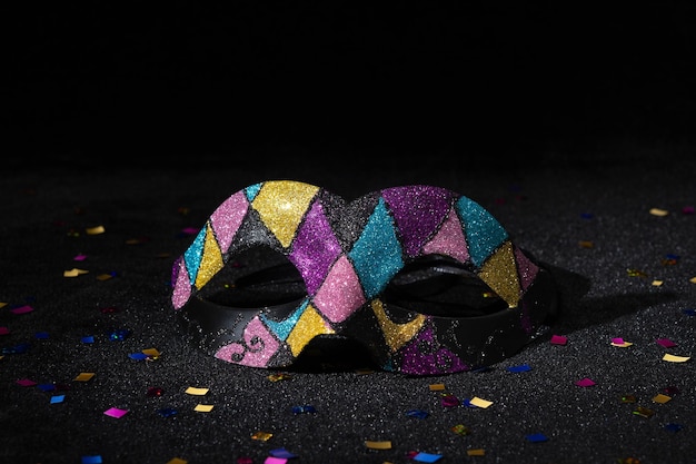 Carnival mask with glitters on black background