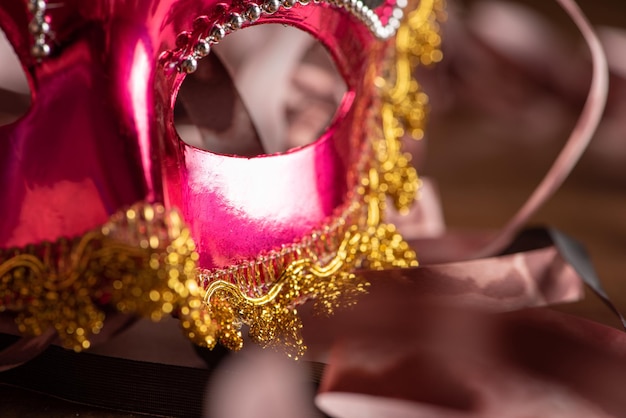 Carnival masks beautiful venetian masks in detail with serpentine on a table selective focus