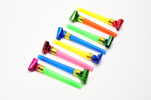 Carnival whistles for Christmas holidays in different colors on isolated white background