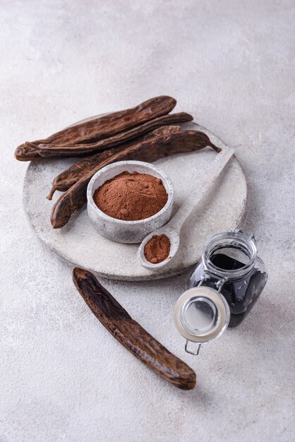 Carob pods powder and molasses or syrup