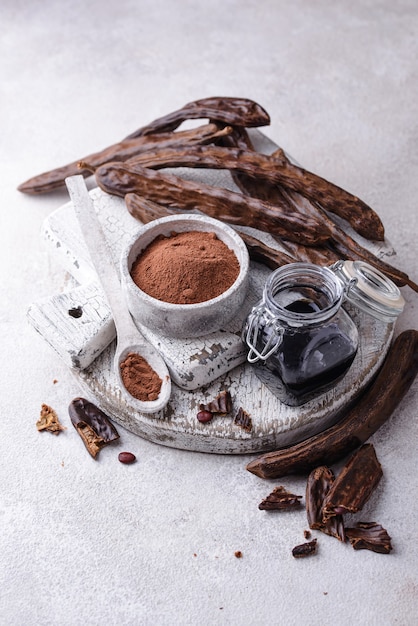 Carob pods powder and molasses or syrup