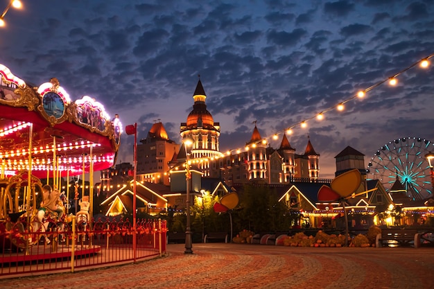 Carousel in the night autumn park. Sochi Park in the Olympic Village. Sochi, Russia - October 15, 2021.