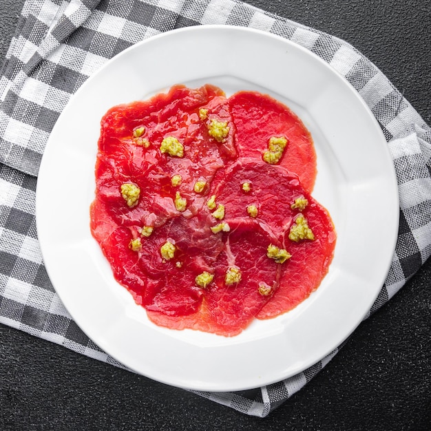 carpaccio spice meat raw appetizer olives, beef thin slices fresh healthy meal food snack