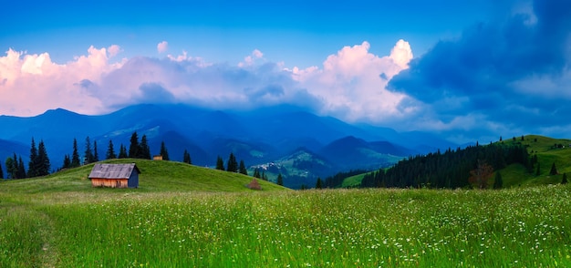 Carpathian mountains summer landscape with cloudy sky and house natural summer travel background Panoramic view