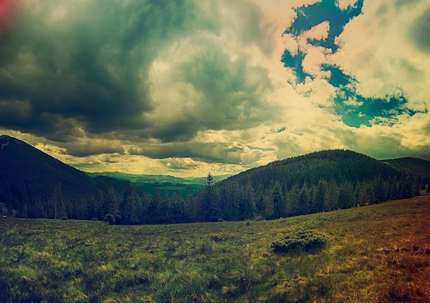 Carpathian mountains summer vintage landscape with blue sky and clouds