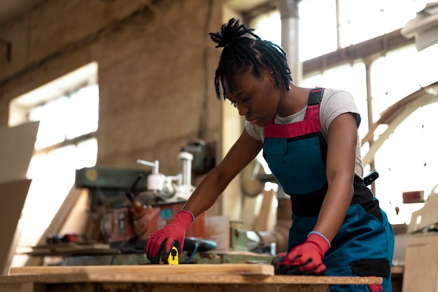 Carpenter cutting mdf board inside workshop