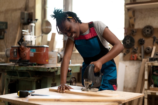 Carpenter cutting mdf board inside workshop