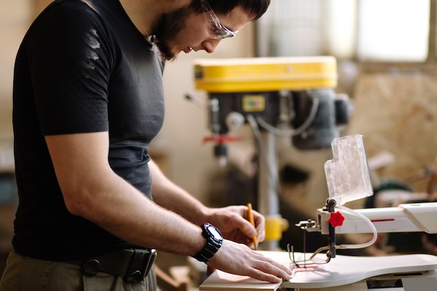 Carpenter engaged in processing wood at the sawmill.