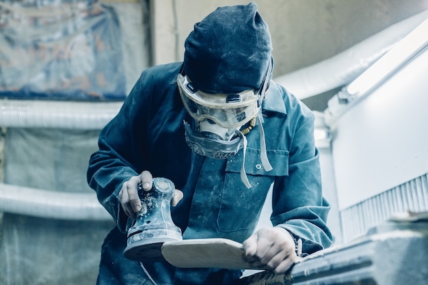 Carpenter manufacturing skateboard decks in his workshop