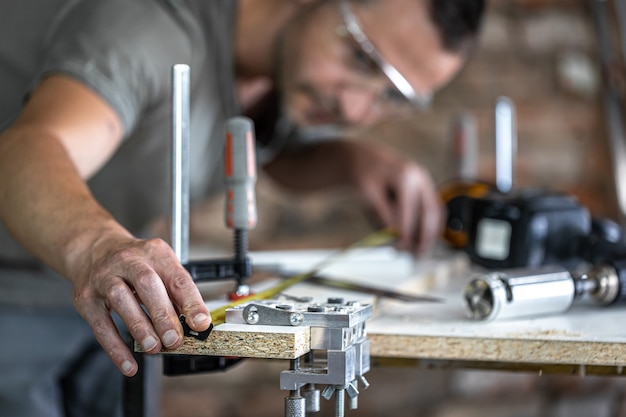 A carpenter in the process, a professional tool for precision drilling in wood.