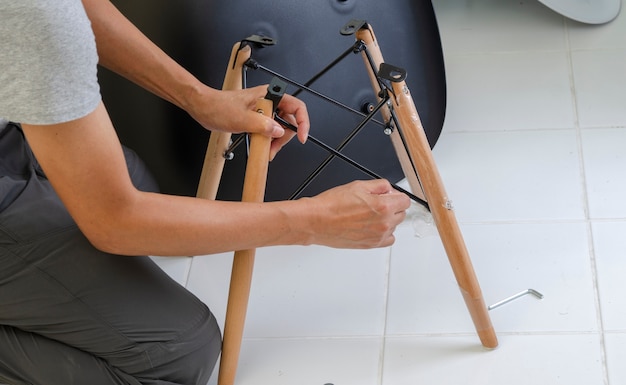 Carpenter putting together parts of chair