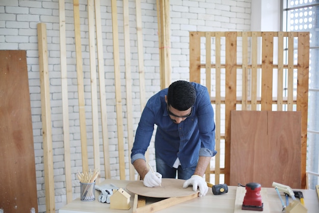 Carpenter or warehouse worker choosing raw wood material for the work at the carpentry storage