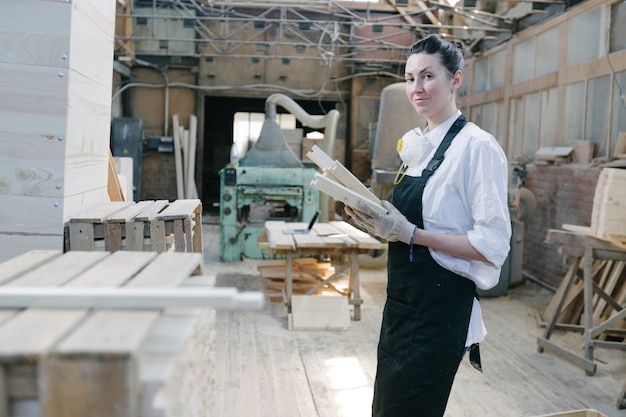 Carpenter woman portraitin her own woodshop