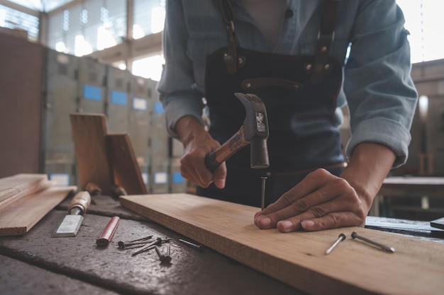 Carpenter working with equipment on wooden table in carpentry shop woman works in a carpentry shop