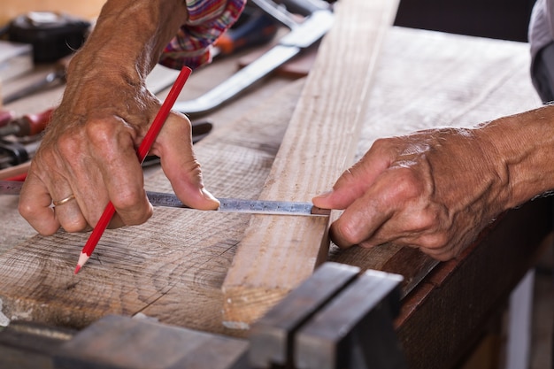 Carpenter working on the work bench joinery tools and woodwork