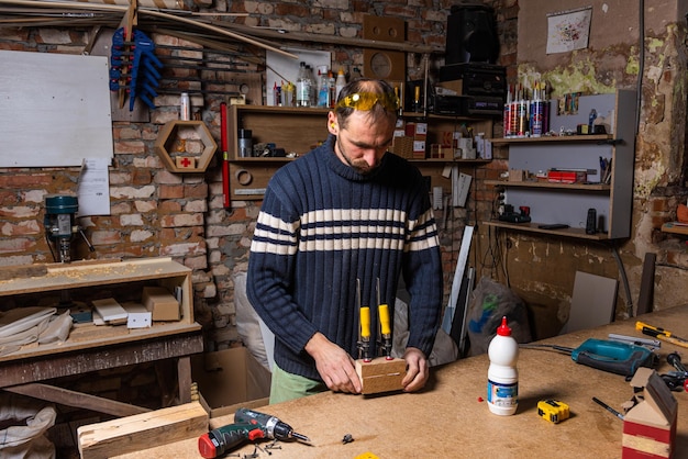 A carpenter works in a furniture workshop