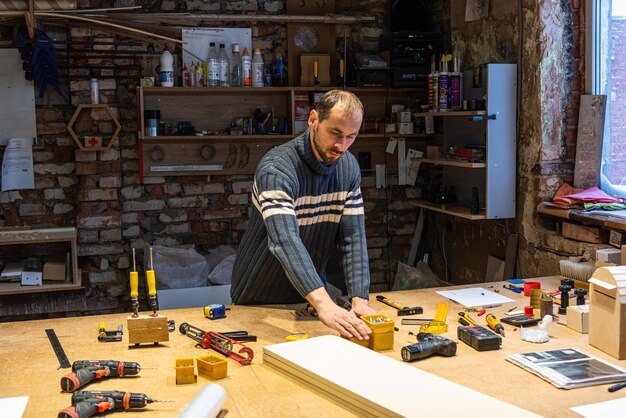 A carpenter works in a furniture workshop