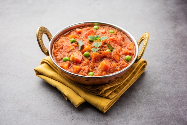 Carrot Curry or Garar Gravy sabzi made using tomato puree and spices, served in a bowl