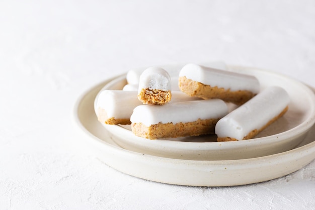 Carrot sticks with coconut cream on a light background Sugar gluten and lactose free and vegan