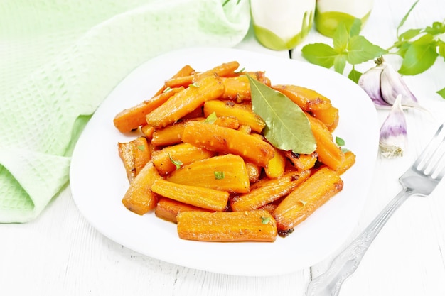 Carrots fried in plate on board