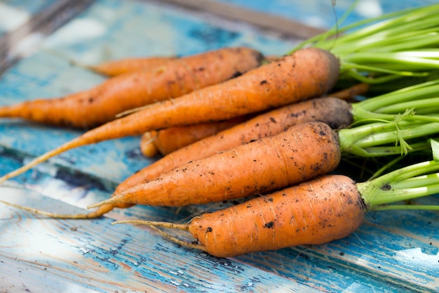 Carrots on a vintage wooden background