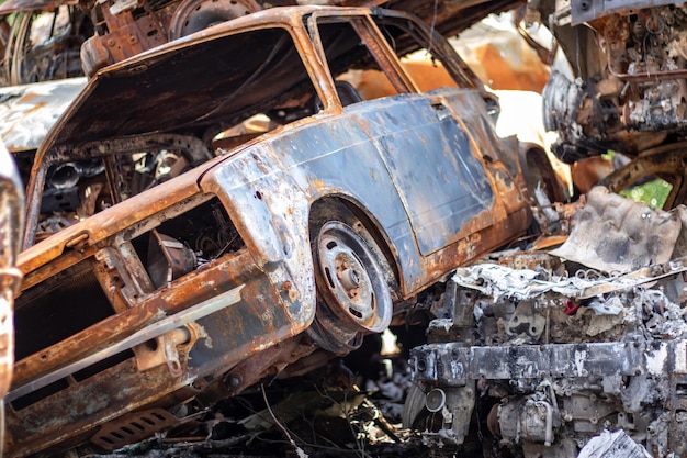 Cars after the fire Iron parts of a burnt car Burntout cars abandoned on the side of a quiet