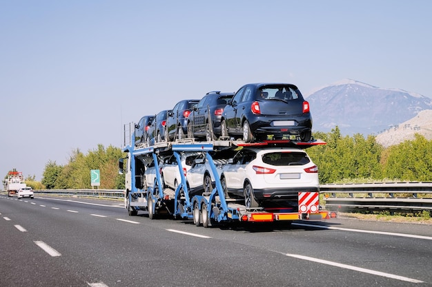 Cars carrier in the road. Truck transporter