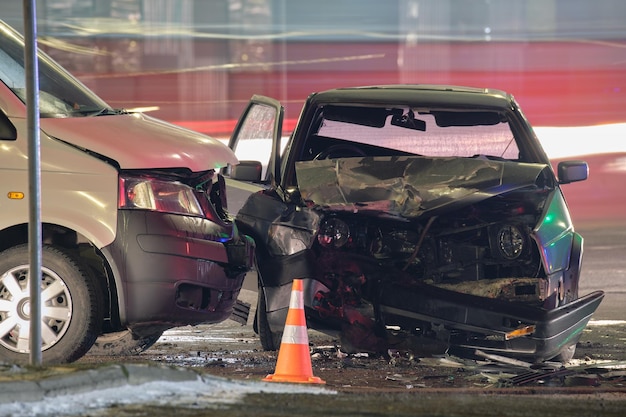 Cars crashed heavily in road accident after collision on city street at night Road safety and insurance concept