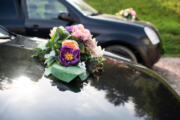 A cars decorated with flawers on wedding