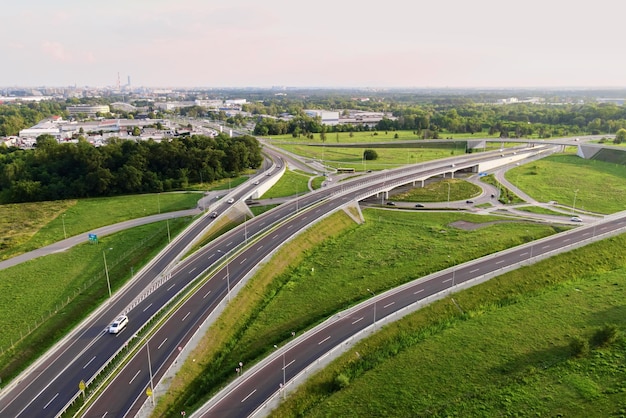 Cars moving on transport road junction in city aerial view