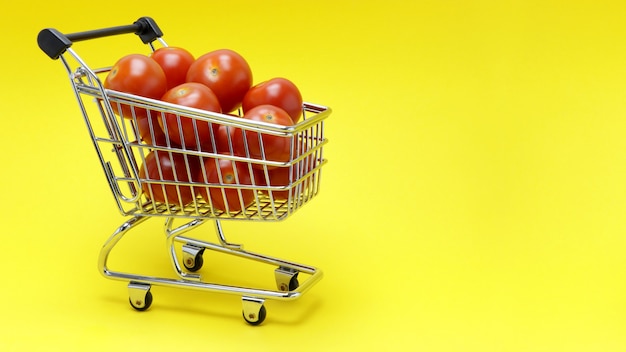 Cart from the hypermarket with fresh juicy tomatoes