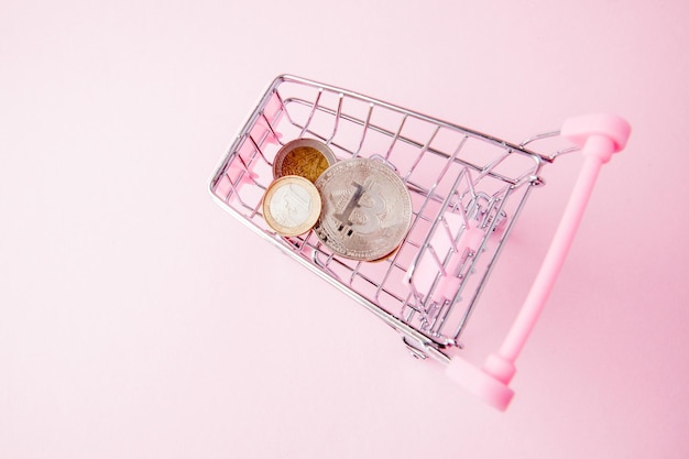 A cart from a supermarket bitcoin on a wooden background internet crypto currency