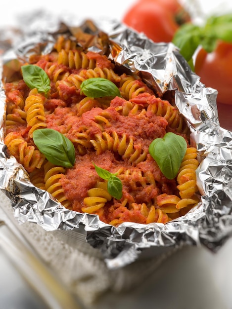 Cartoccio pasta tomatoes selective focus