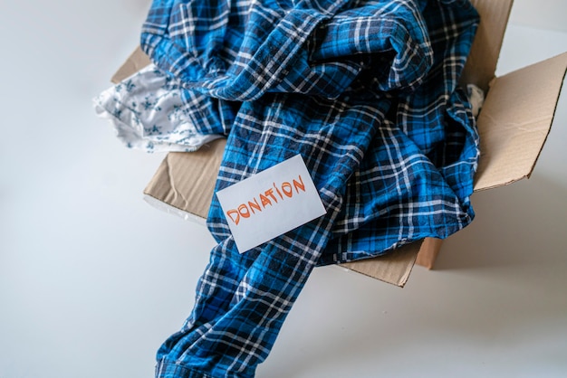 A carton box with clothes inside, a donation to children from poor countries