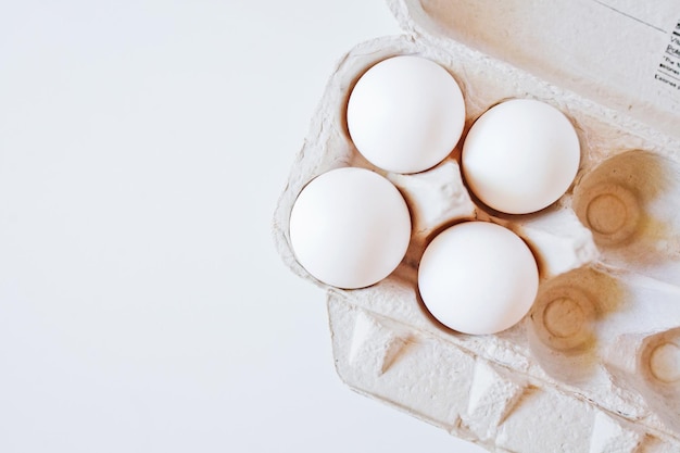 A carton of eggs on the table top view white background