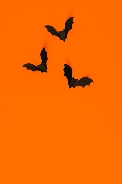 Cartoon halloween background black bats on orange backdrop Bright holiday backdrop for your design Dark and moody background Place for text