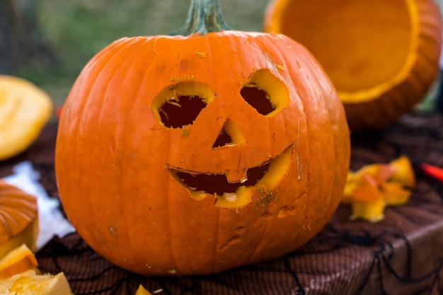 Carving big orange pumpkins for Halloween in late Autumn.