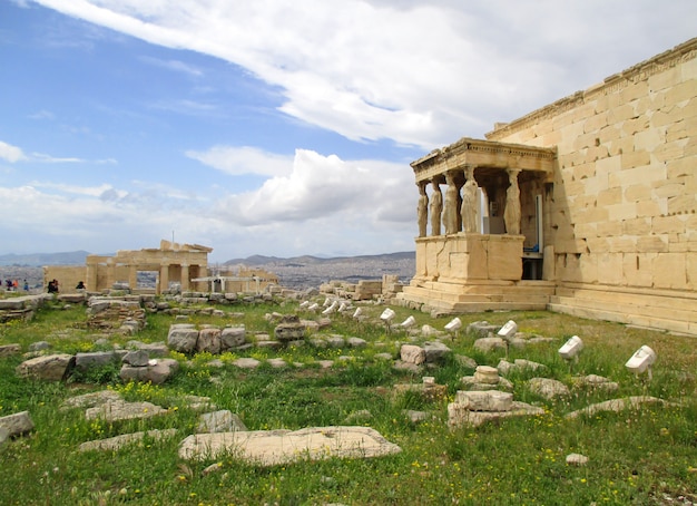 Caryatid Columns of the Porch of Erechtheion Ancient Greek Temple with Propylaea Monumental Gate in the Distance