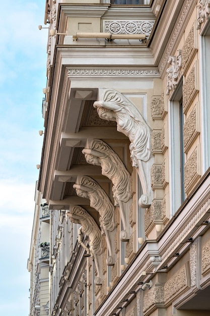 Caryatid is supporting balcony on the facade of historical building in SaintPetersburg Russia