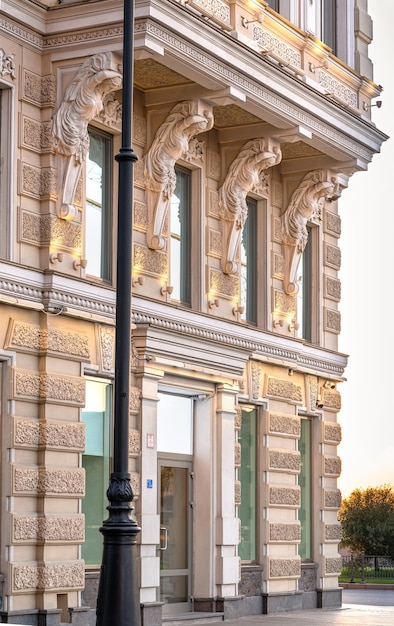 Caryatid is supporting balcony on the facade of historical building in SaintPetersburg Russia