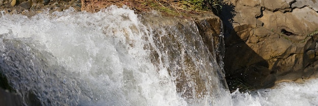 Cascade of waterfalls among the stones mountain river concept